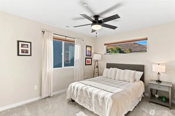 a bedroom with a large bed and a chandelier