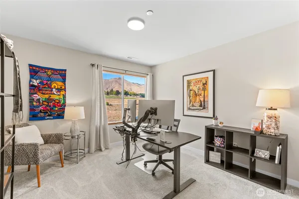 a view of a livingroom with furniture and a workspace