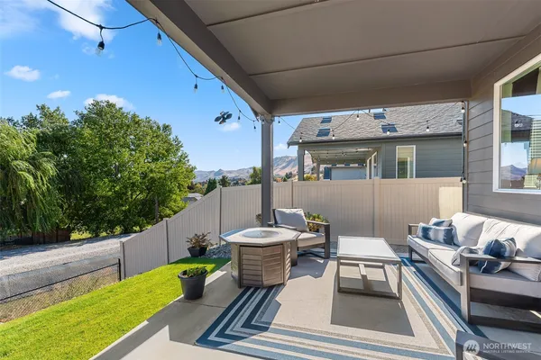 a view of a patio with a dining table and chairs with wooden floor