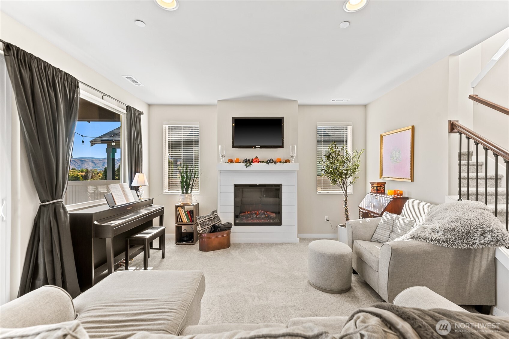 143 Sienna Road Wenatchee, WA 98801 - Photo 4 of 40 a living room with furniture a flat screen tv and a fireplace