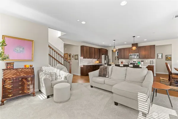 a living room with furniture kitchen view and a table