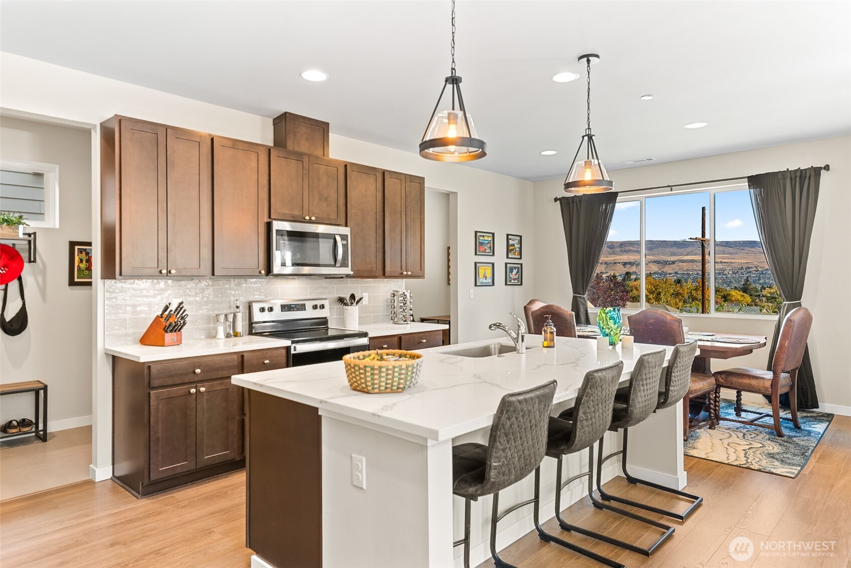 143 Sienna Road Wenatchee, WA 98801 - Photo 9 of 40 a kitchen with stainless steel appliances granite countertop a stove top oven a sink dishwasher and white cabinets with wooden floor