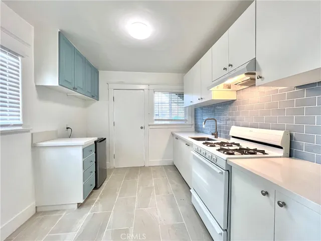 a kitchen with a stove and a sink