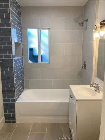 a bathroom with a bathtub and shower