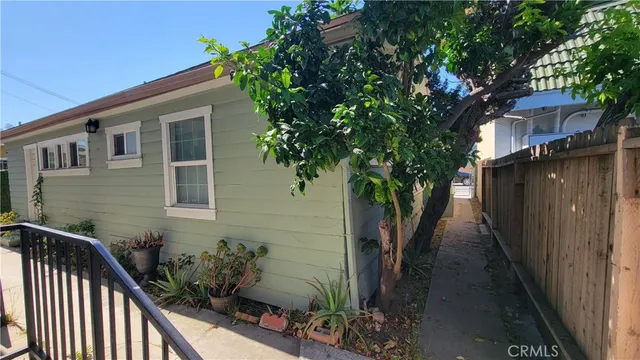 a house with potted plants in front of it