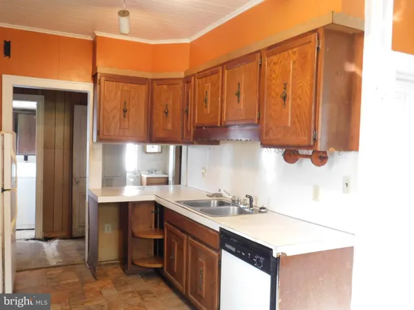 a kitchen with a sink cabinets and utility