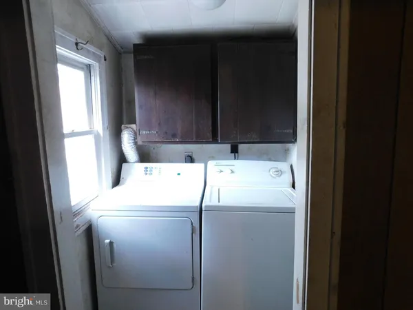 a bathroom with a toilet sink and window