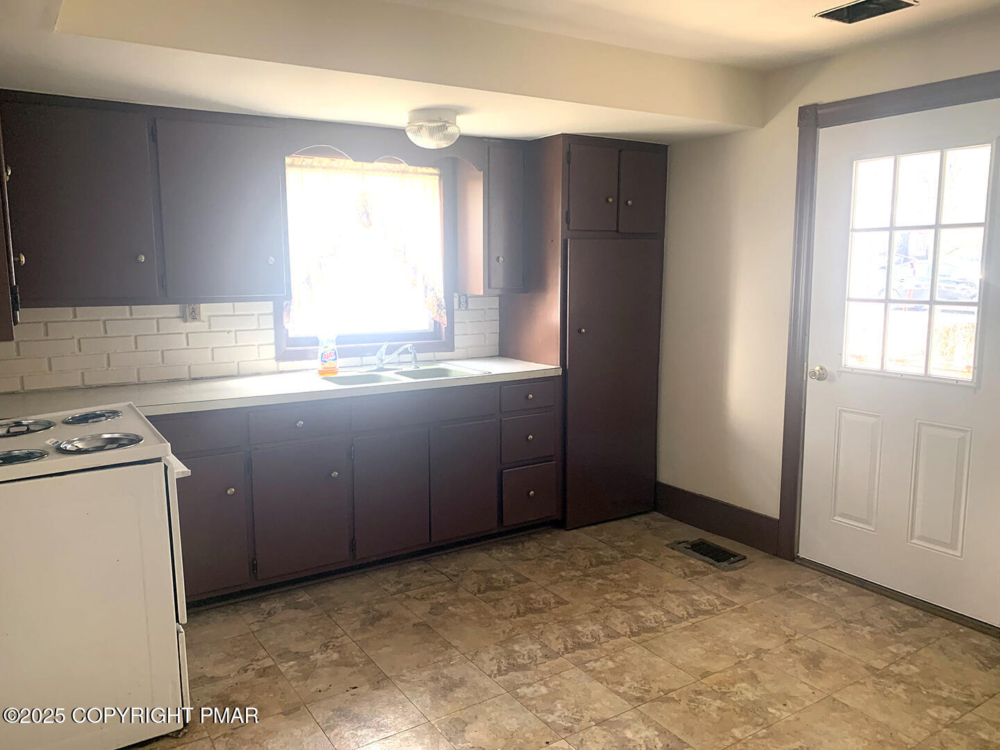729 Ann Street Stroudsburg, PA 18360 - Photo 13 of 21 a room with a stove a washer and dryer with wooden cabinets