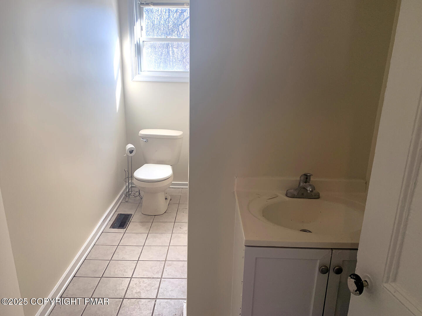 729 Ann Street Stroudsburg, PA 18360 - Photo 16 of 21 a bathroom with a sink a toilet and a window