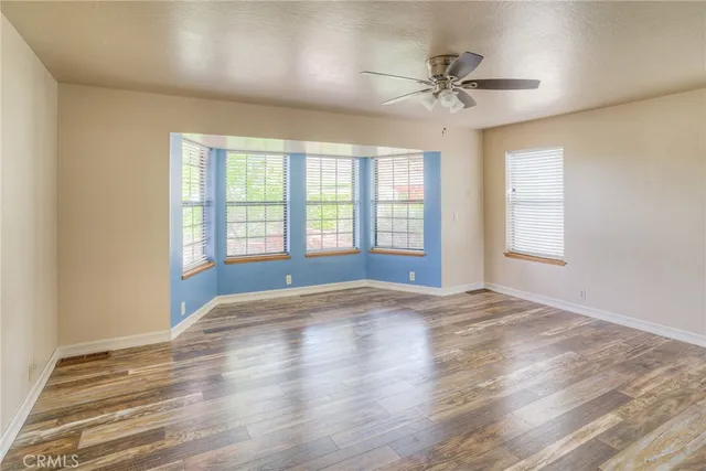 a living room with a large mirror and furniture