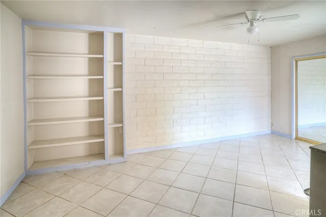 a front view of a house with a yard and potted plants
