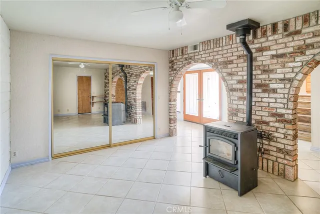 a view of a patio with a table and chairs under an umbrella
