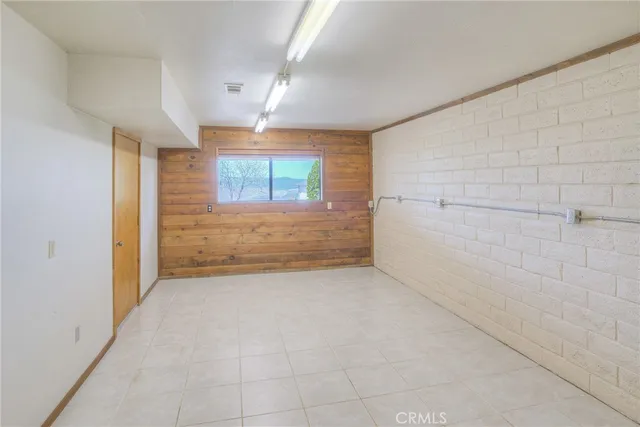 an aerial view of a house with a yard and lake view