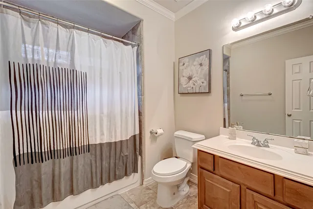 a bathroom with a toilet a sink and a mirror