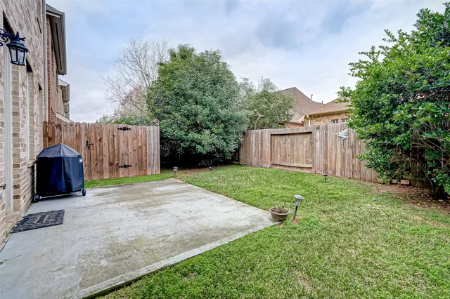 a view of backyard of house with green space