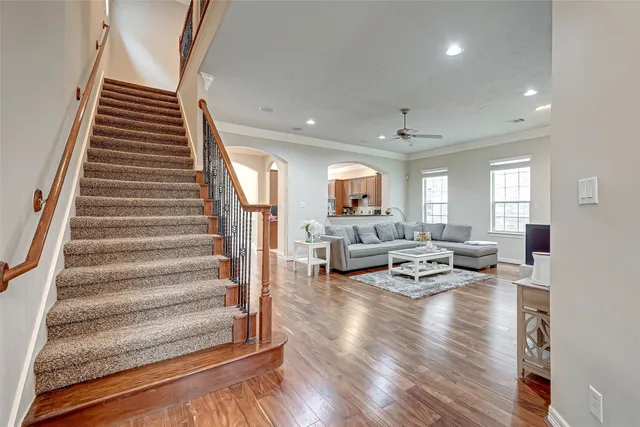 a living room with furniture and wooden floor