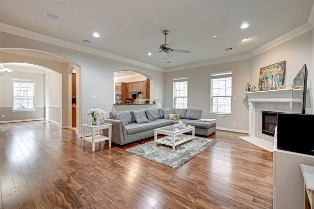 a living room with fireplace furniture and a wooden floor