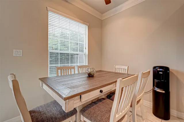 a dining room with a table and chairs