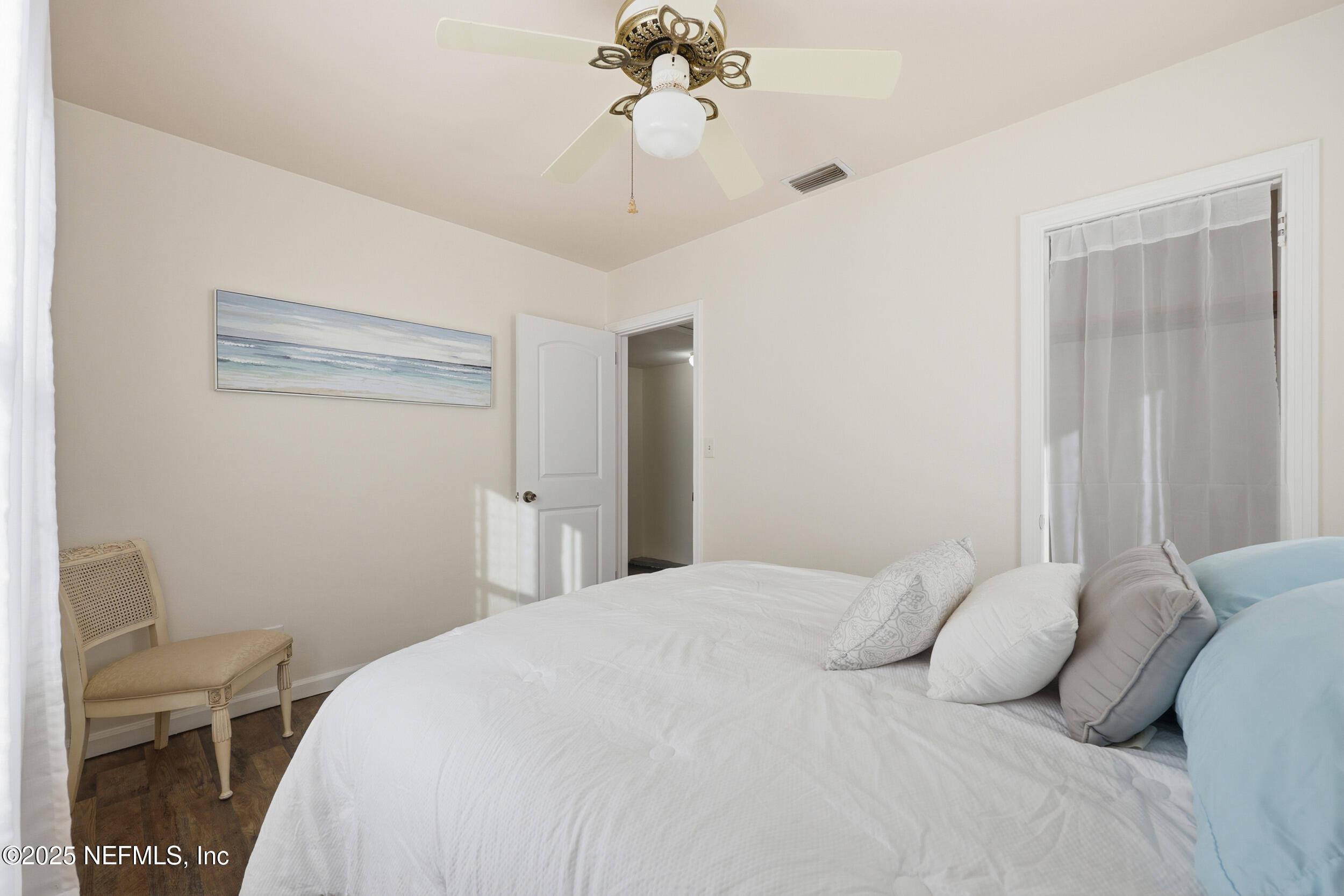 2947 Kline Road Jacksonville, FL 32246 - Photo 14 of 29 a bedroom with a bed and a chandelier