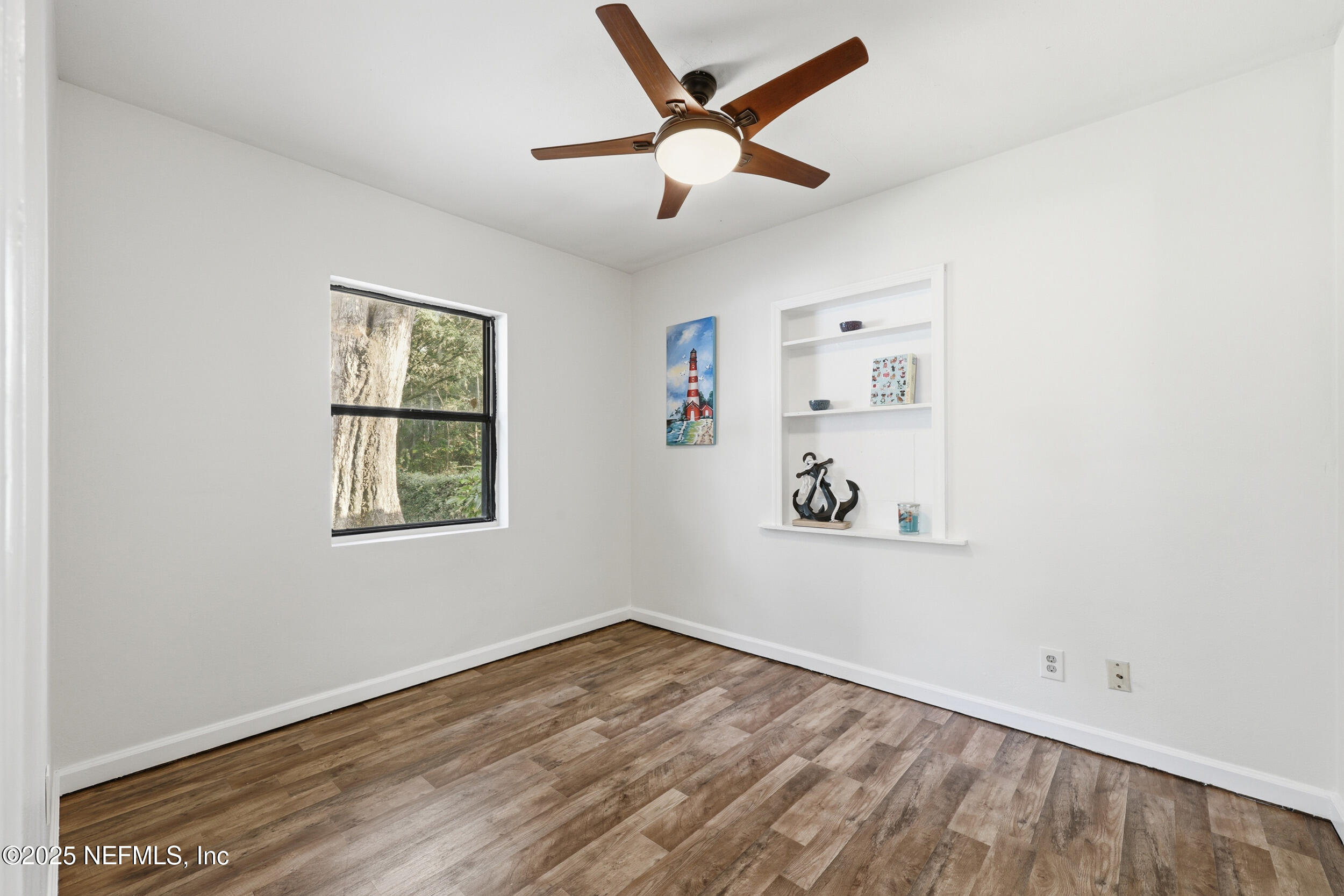 2947 Kline Road Jacksonville, FL 32246 - Photo 17 of 29 an empty room with wooden floor and windows
