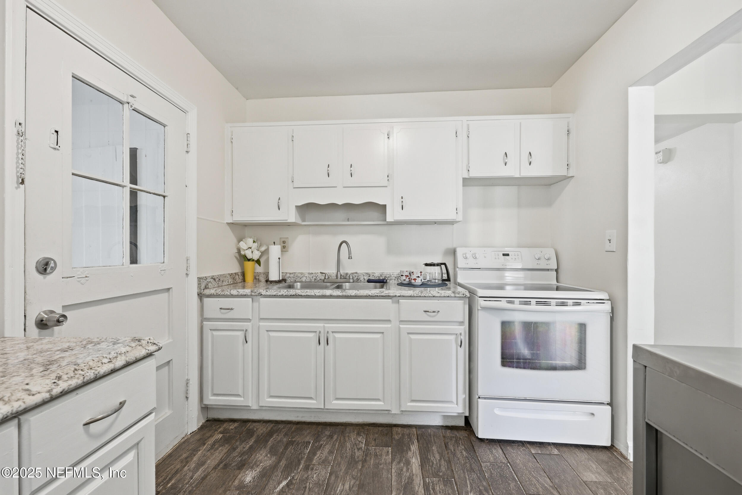 2947 Kline Road Jacksonville, FL 32246 - Photo 7 of 29 a kitchen with granite countertop white cabinets and white appliances