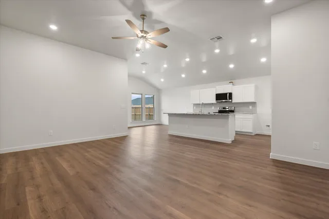 a view of a kitchen with a sink and a stove top oven