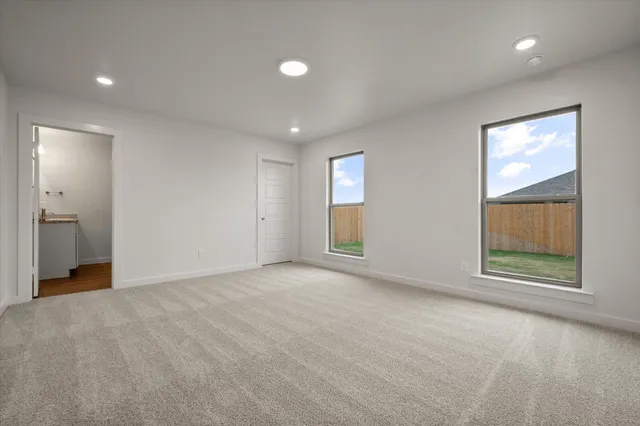 an empty room with windows and closet