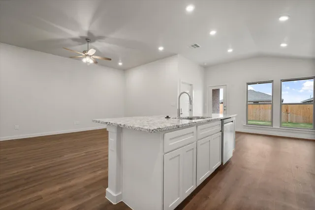 a view of a kitchen with a sink and chandelier