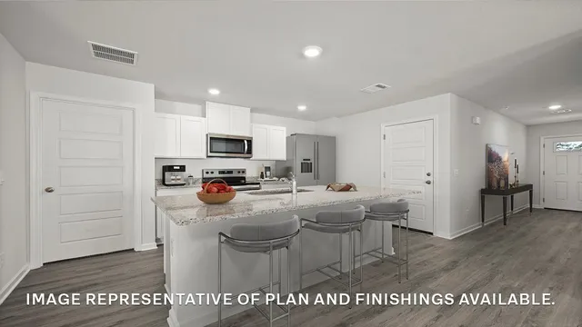 a kitchen with stainless steel appliances a white cabinets stove and refrigerator