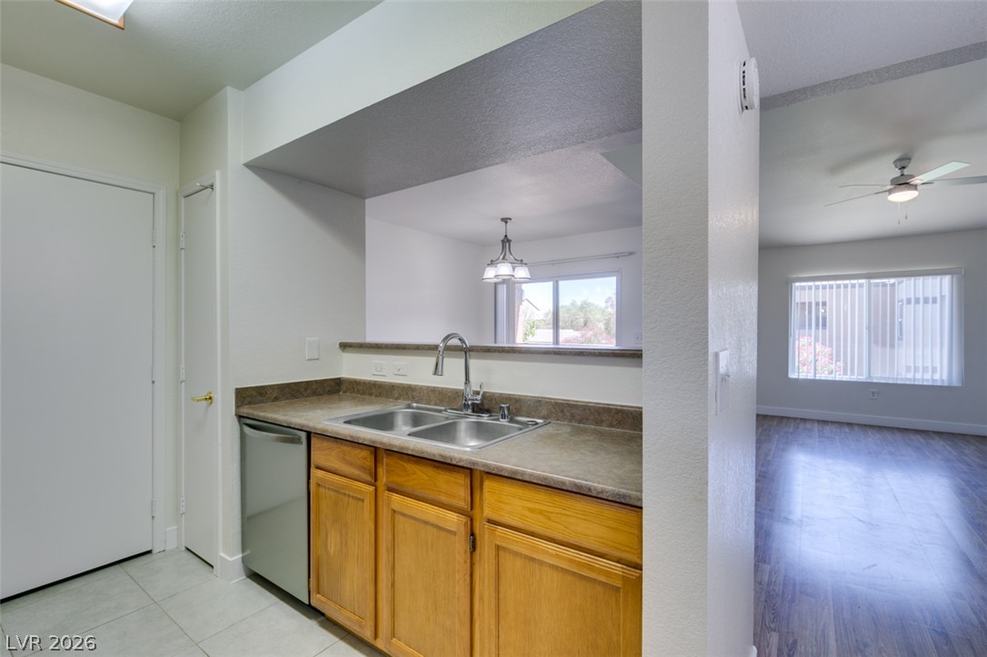 6650 West Warm Springs Road, Unit 2118 Las Vegas, NV 89118 - Photo 1 of 41 A well-appointed kitchen features a double basin sink and a convenient pass-through to the adjacent living area.