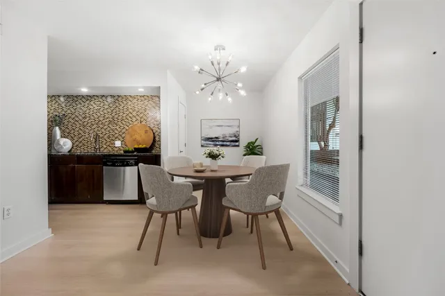 a view of a dining room with furniture and chandelier