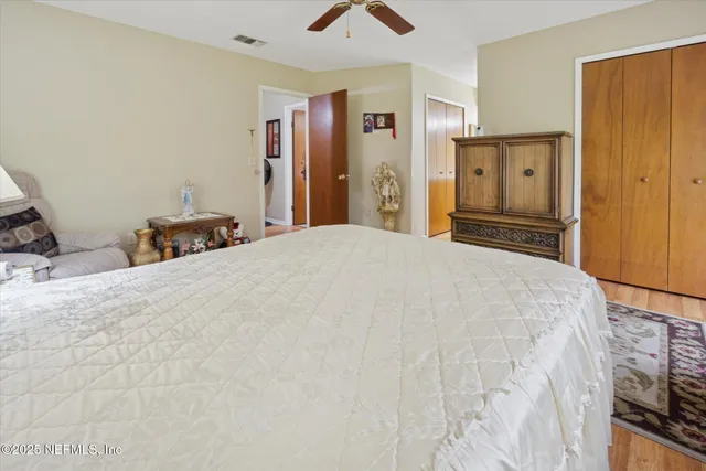 a bedroom with a large bed and a chandelier