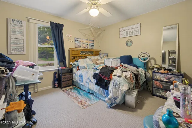 a bed room with a bed mirror and a window