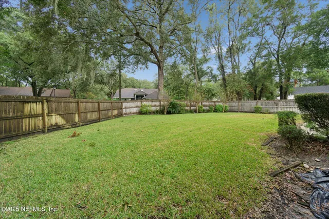 a view of a backyard with a garden and trees