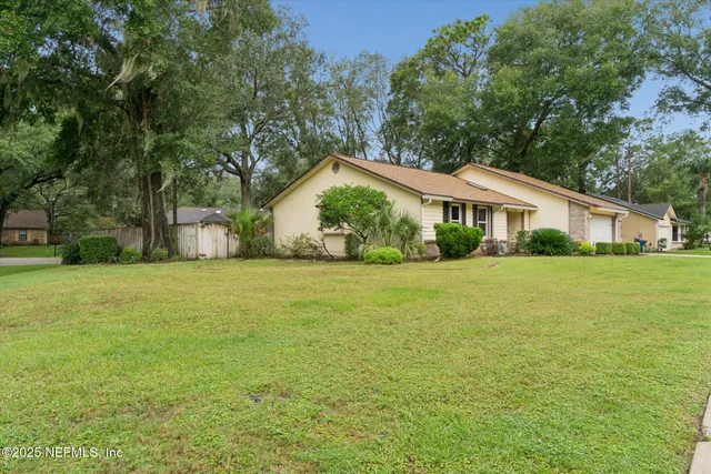 a front view of house with yard and green space