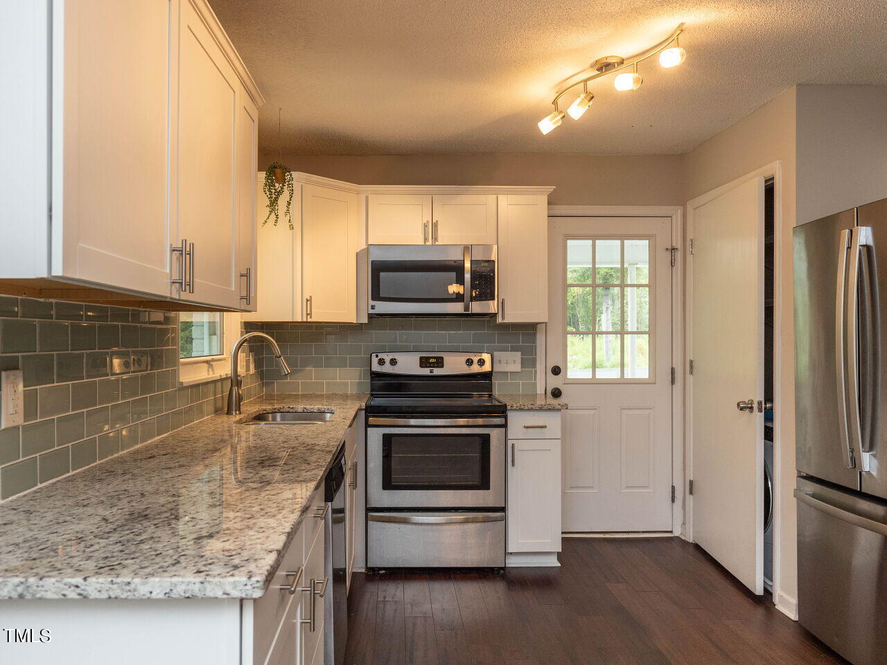 809 Lakeview Road Durham, NC 27712 - Photo 11 of 49 a kitchen with kitchen island granite countertop a stove and a sink