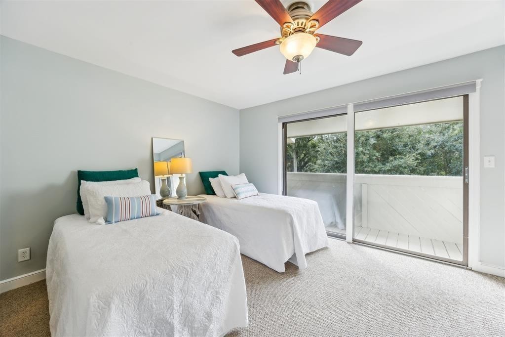 3033 Sea Marsh Road Fernandina Beach, FL 32034 - Photo 19 of 37 a bedroom with two large bed and two large window