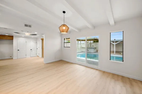 a large kitchen with a table and chairs