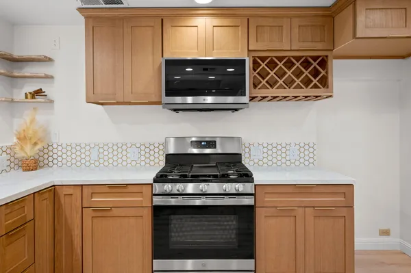 a stove top oven sitting inside of a kitchen