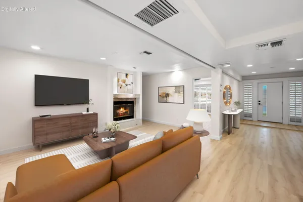 a view of empty room with wooden floor and fireplace