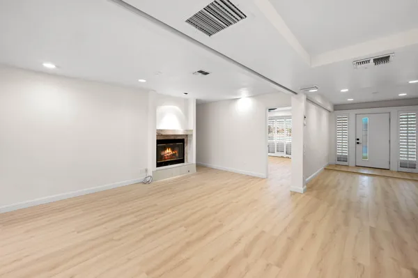 a living room with furniture kitchen view and a large window