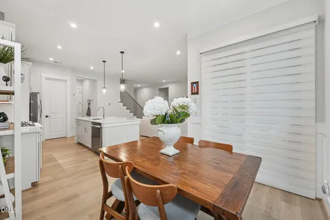 a dining room with furniture and wooden floor