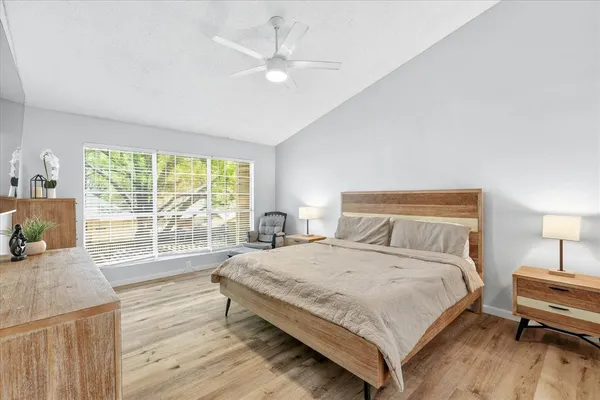 a bedroom with a large bed and a large window