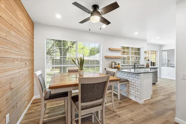 a dining room with furniture window and wooden floor