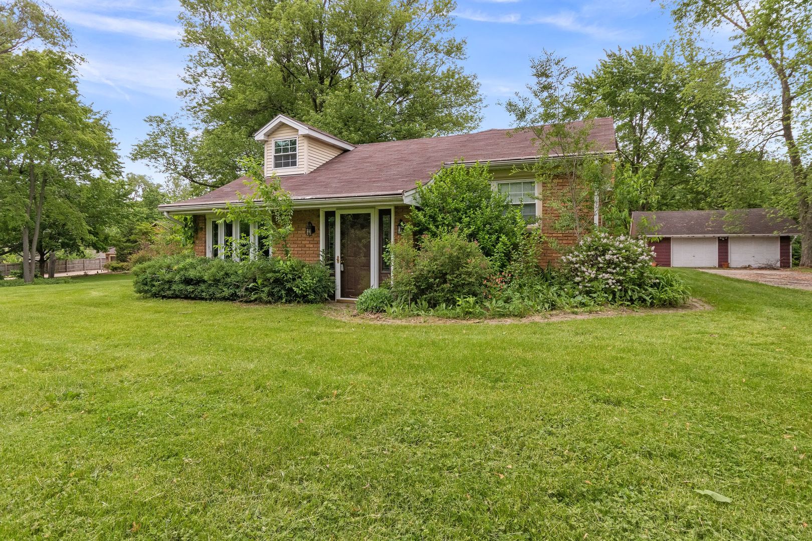 a front view of house with yard and green space