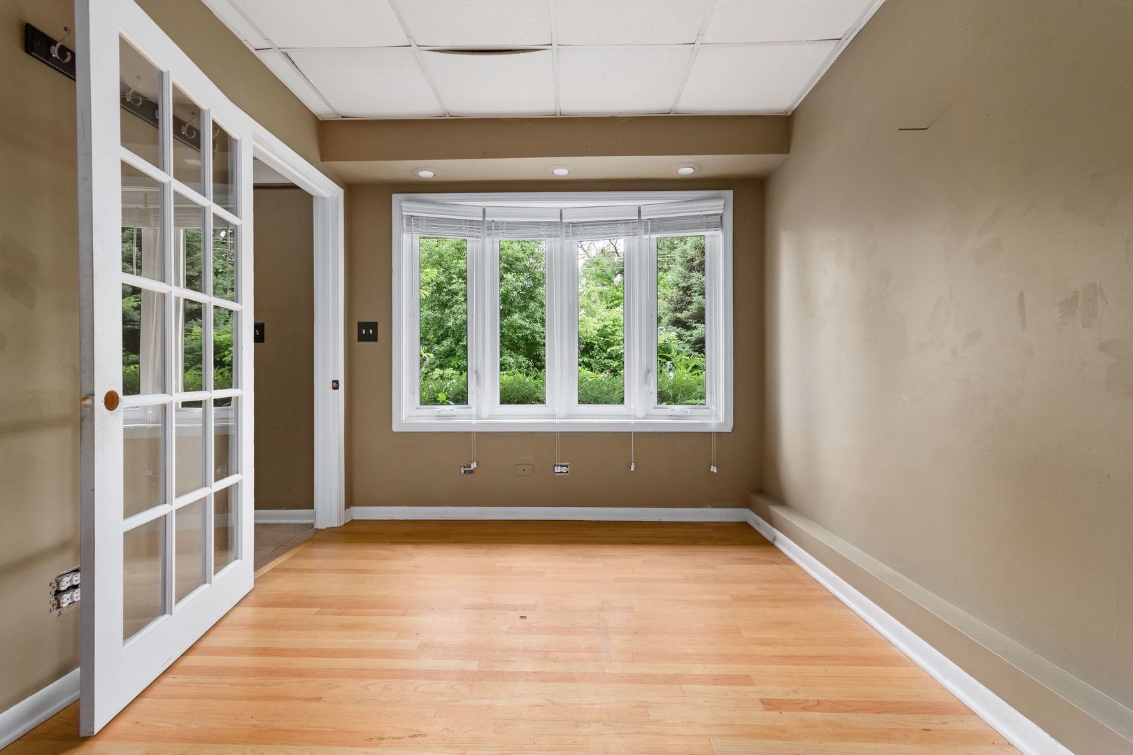 N659 Old Kirk Road West Chicago, IL 60185 - Photo 13 of 24 a view of an empty room with wooden floor and a window