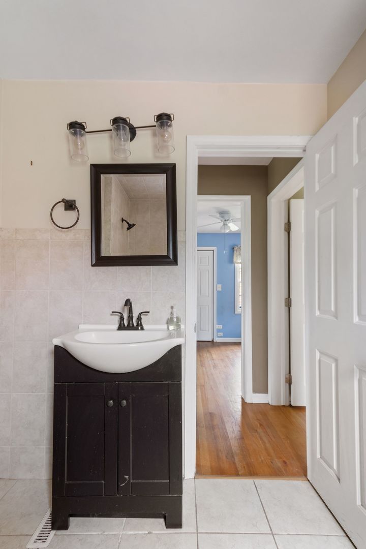 N659 Old Kirk Road West Chicago, IL 60185 - Photo 17 of 24 a bathroom with a sink and a mirror