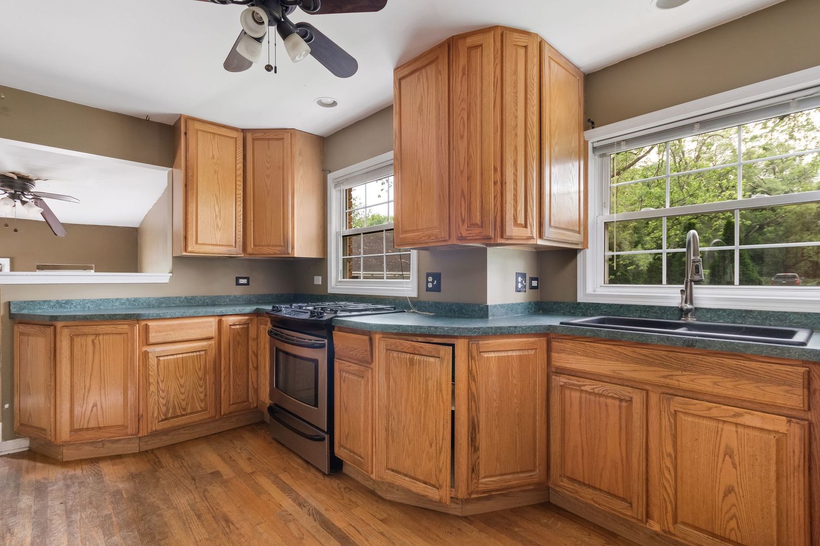 N659 Old Kirk Road West Chicago, IL 60185 - Photo 2 of 24 a kitchen with granite countertop wooden cabinets a sink a window and appliances