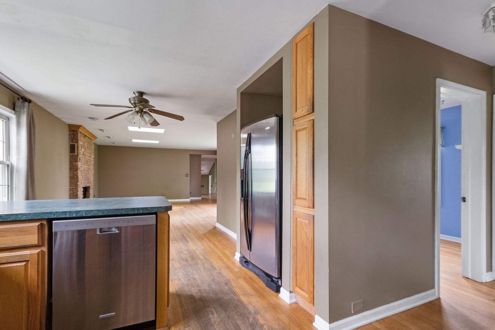 N659 Old Kirk Road West Chicago, IL 60185 - Photo 4 of 24 a kitchen with stainless steel appliances granite countertop a refrigerator a sink and wooden floors