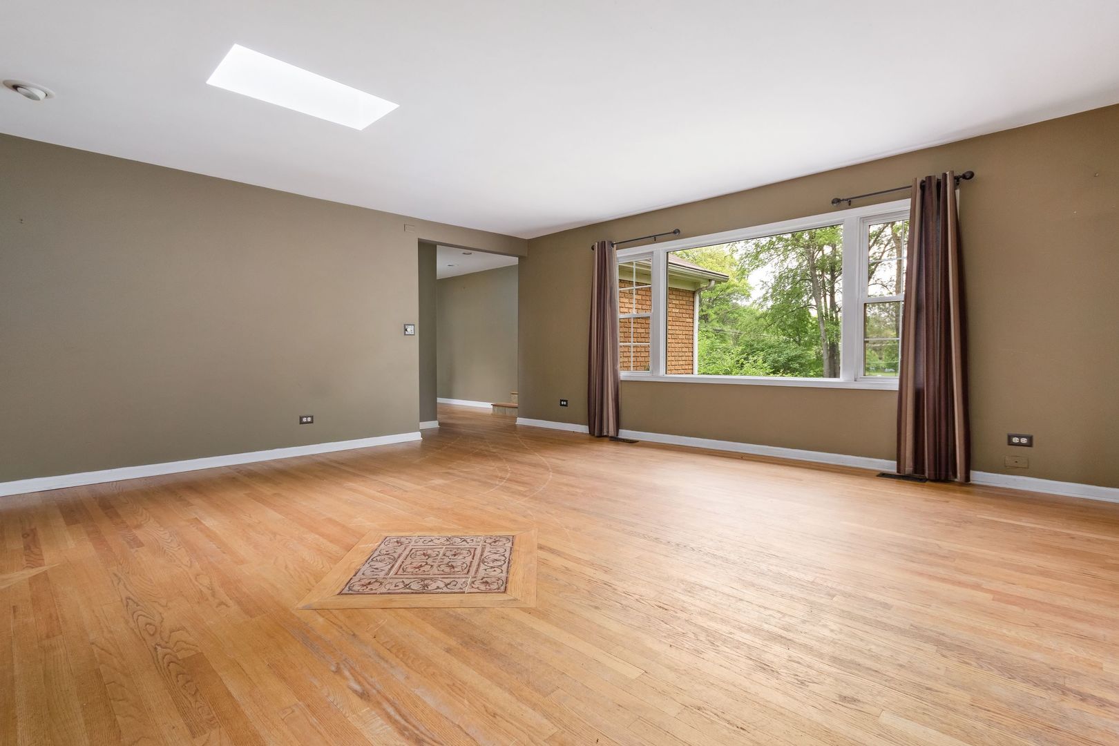 N659 Old Kirk Road West Chicago, IL 60185 - Photo 6 of 24 a view of an empty room with wooden floor and a window